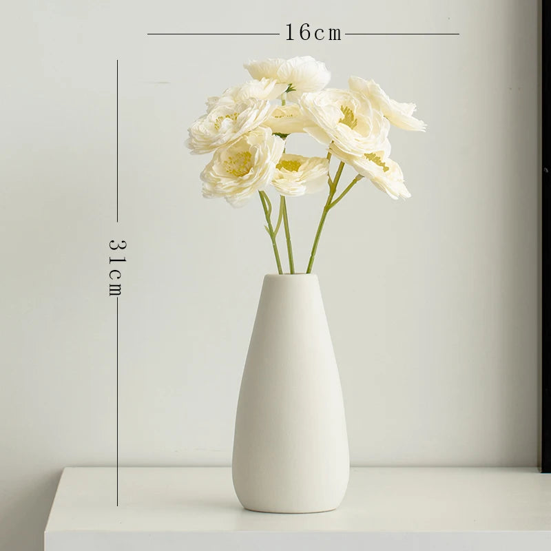 Minimalist white ceramic vase with silk flowers measuring 31cm tall and 16cm wide