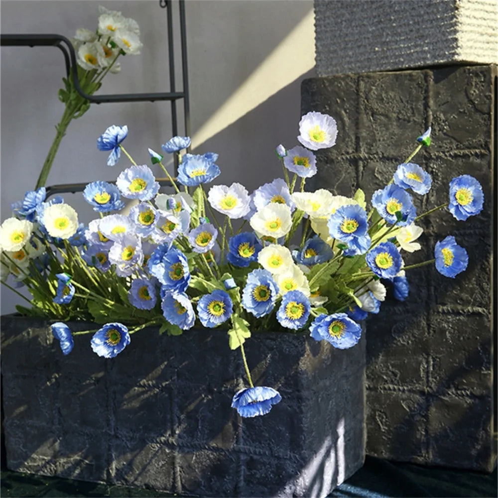 Blue and white artificial flower arrangement in a decorative gray planter for home decor