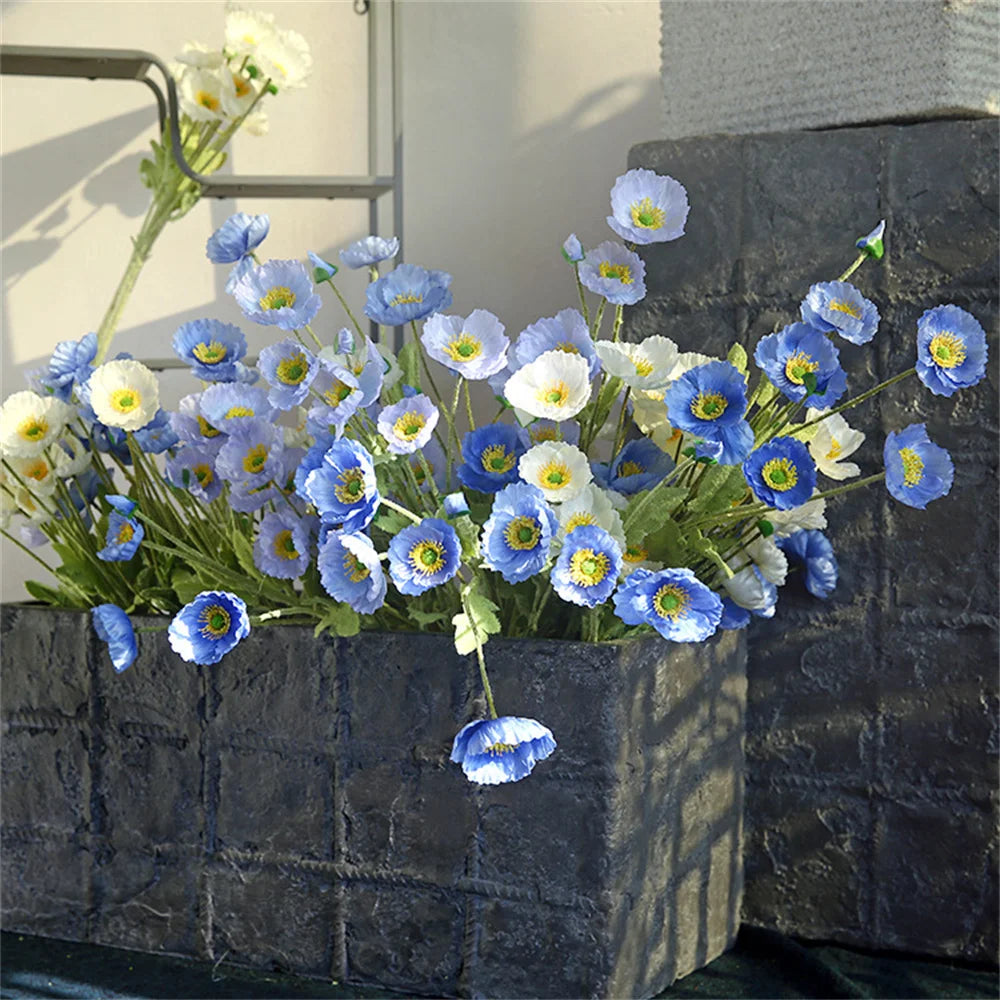 Beautiful Mağazam decorative flower arrangement in blue and white in textured black planter