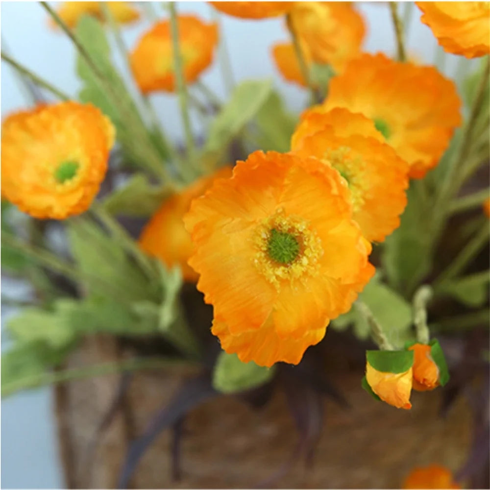 Vibrant orange artificial flowers in a decorative vase by Mağazam, ideal for home decor
