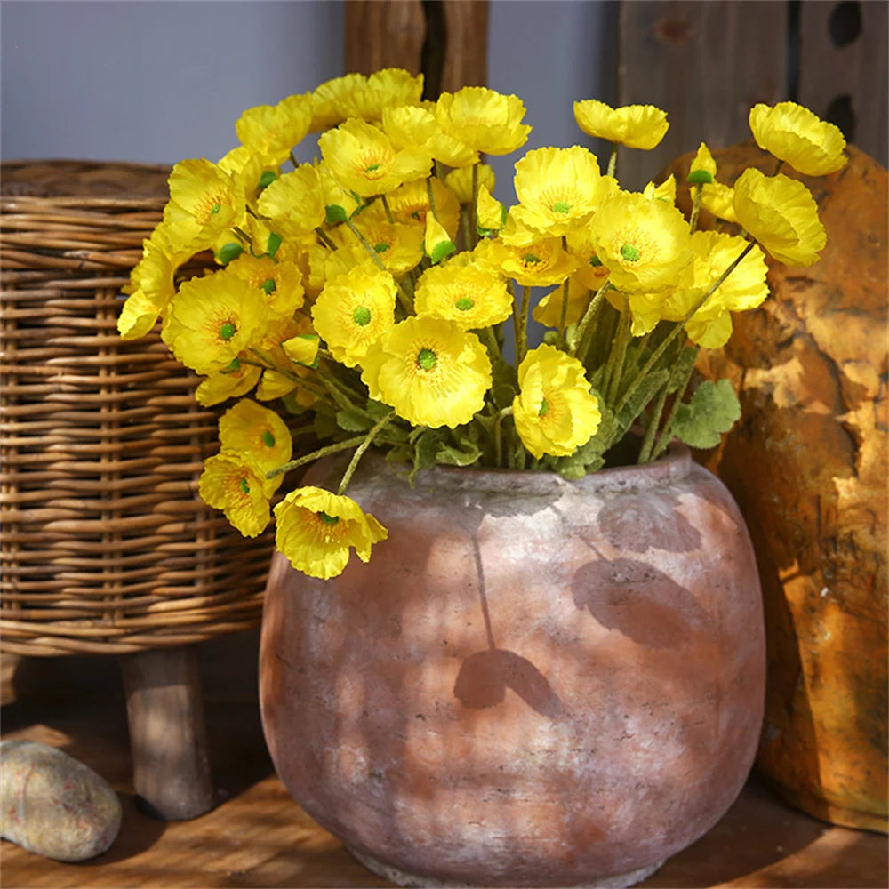 Ceramic vase with vibrant yellow artificial flowers for home decor and interior design