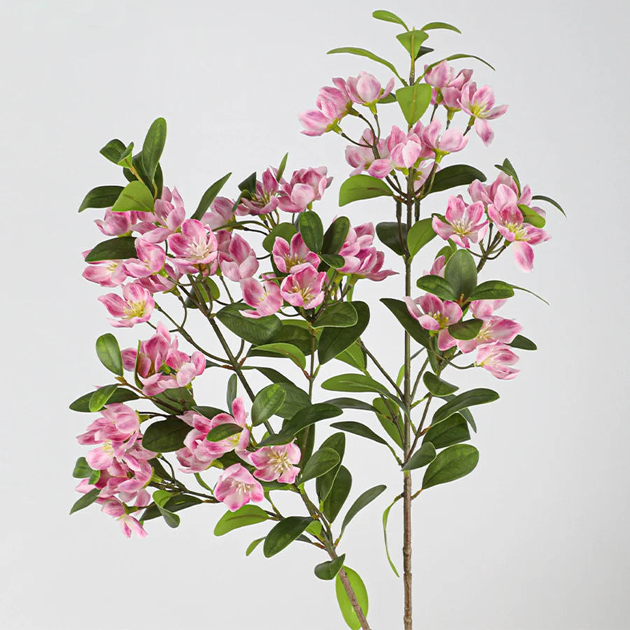 Artificial pink orchid plant with lush green leaves for home decor and floral arrangements