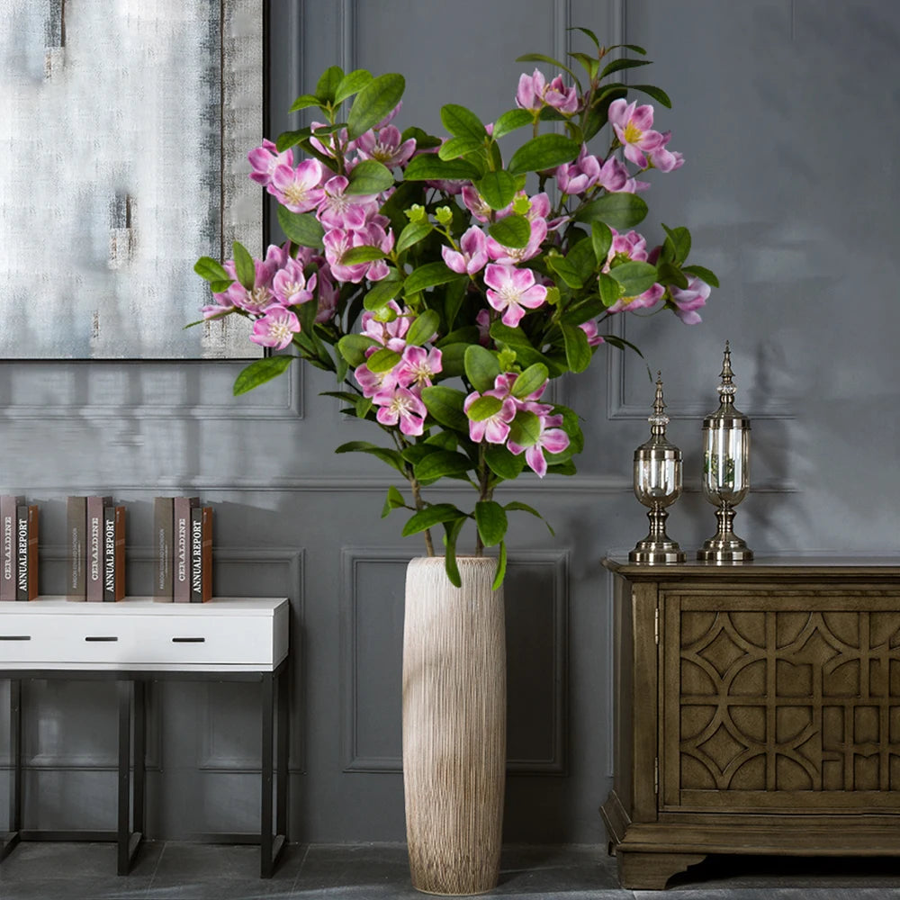 Elegant faux orchid flower arrangement in a tall vase for stylish home decor