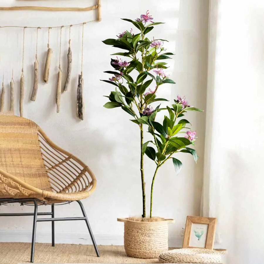 Artificial pink orchid plant in a decorative pot, enhancing home decor in a cozy living space