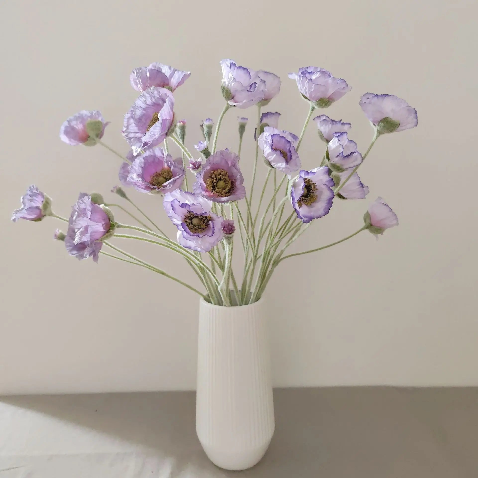 Artificial lavender poppy flower bouquet in a modern white vase for home decor