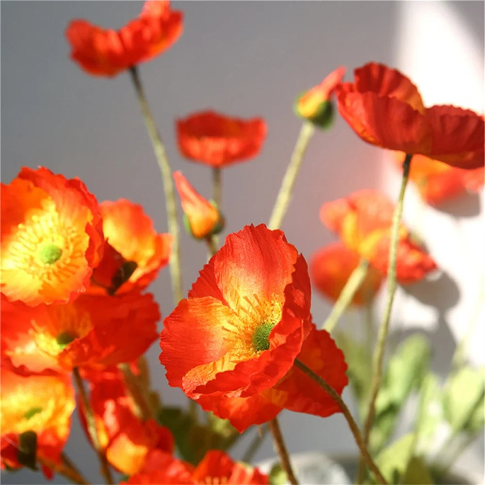 Bright orange and yellow artificial poppy flowers in a decorative arrangement by Mağazam