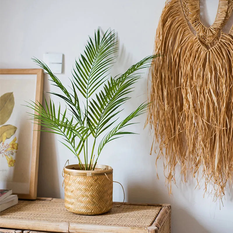 Stylish decorative palm plant in a natural woven basket on a cozy home interior shelf