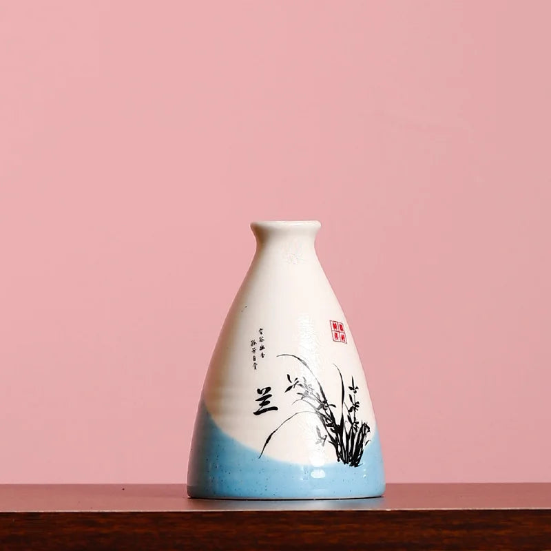 Vintage small flower vase with blue and white glaze and delicate floral design